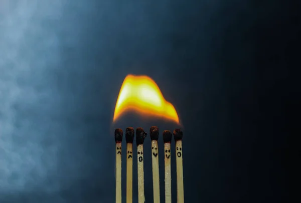 Group of a red match burning isolated with the background. Row burning matchstick in the chain reaction. Matchstick art photography.