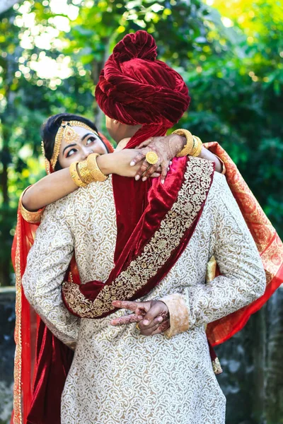 Indian Wedding Couple Hugging Groom Showing Victory Sign Green Bokeh — 图库照片