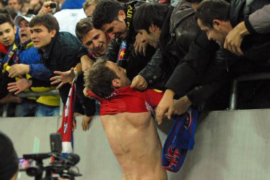 BUCHAREST, ROMANIA - NOVEMBER 3, 2011: FCSB taraftarları Ulusal Arena 'da FCSB ve Maccabi Hayfa arasında oynanan UEFA Avrupa Ligi J Grubu karşılaşması sonrasında Novak Martinoviç' ten tişörtlerini çıkarmaya çalışıyorlar.
