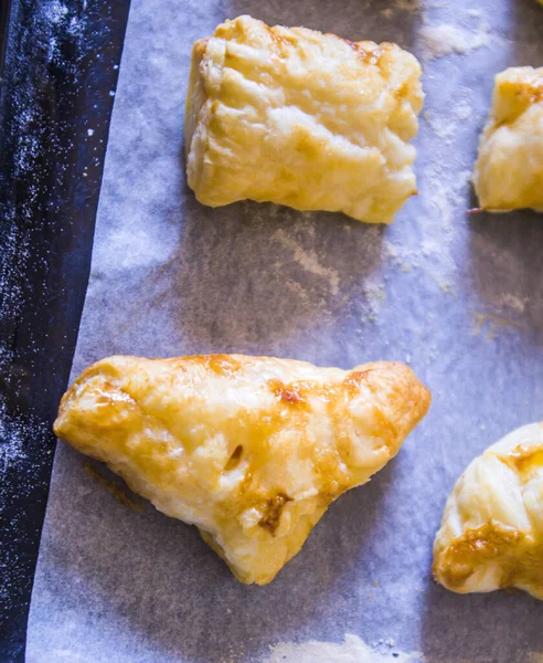 preparation of home-made savory snacks with puff pastry, mortadella, cheese and egg, cooked in the oven