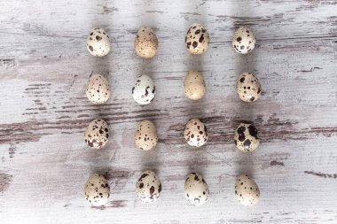 Quail eggs on wooden table background. Concept, template, top view, copy space