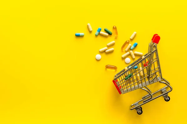 Pharmacy shopping online - grocery cart with medicine and pills