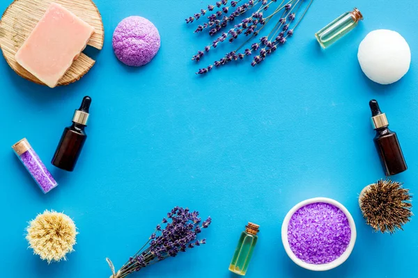 Frame of lavender bath salt and essential oil, top view