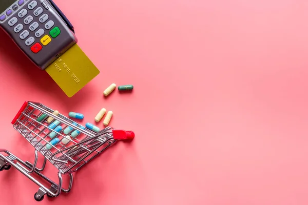 Making medicine purchases - payment terminal with a bank card, top view