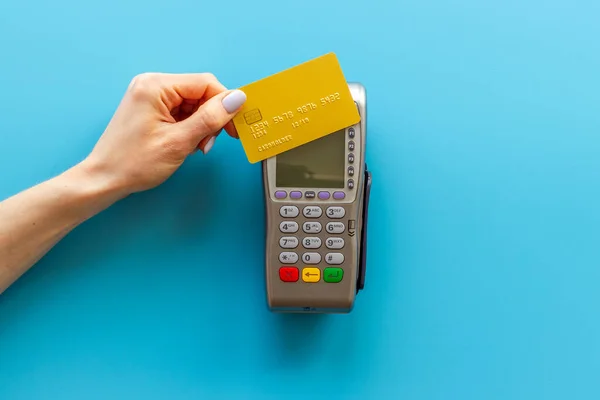 Hand swiping credit card by pos terminal. Payment transactions concept