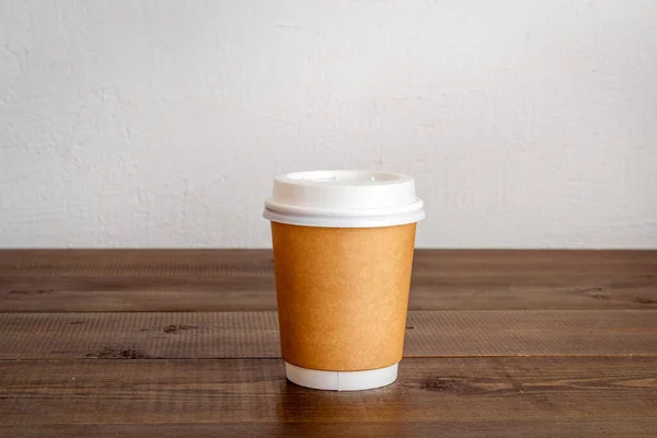 Take out coffee paper cup on the table. Close up