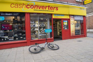 Doncaster, Yorkshire, England - October 7, 2020. Doncaster cash converters with a bicycle left on the floor in front of the store. clipart