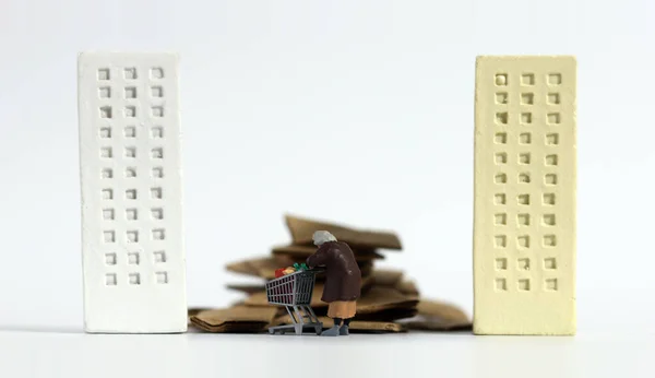 Piles of paper,miniature senior woman  and buildings. Miniature and business concept.