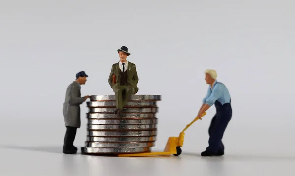 Piles of paper,miniature people  and coins. Miniature and business concept.