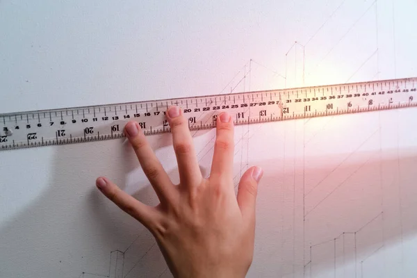 hand holding ruler with canvas background