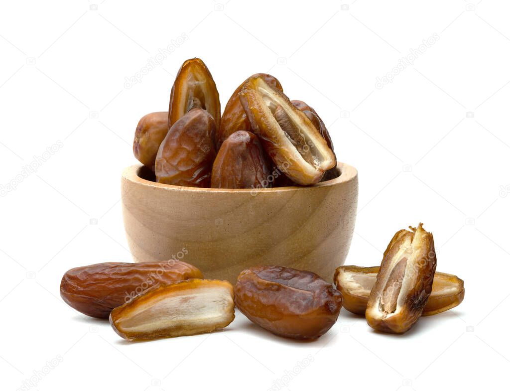 dry dates palm in wooden bowl isolated on white background.