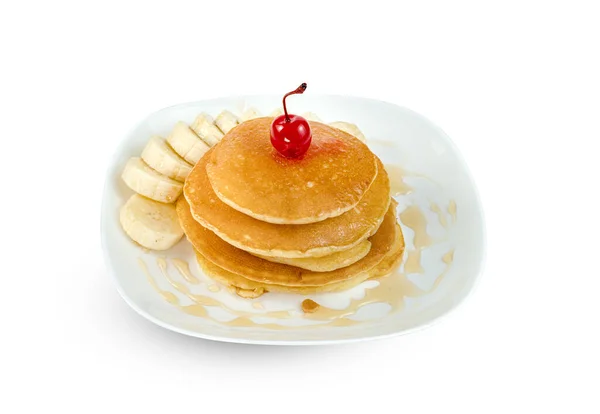 pancakes with banana sliced and cherry in dish isolated on white background ,include clipping path