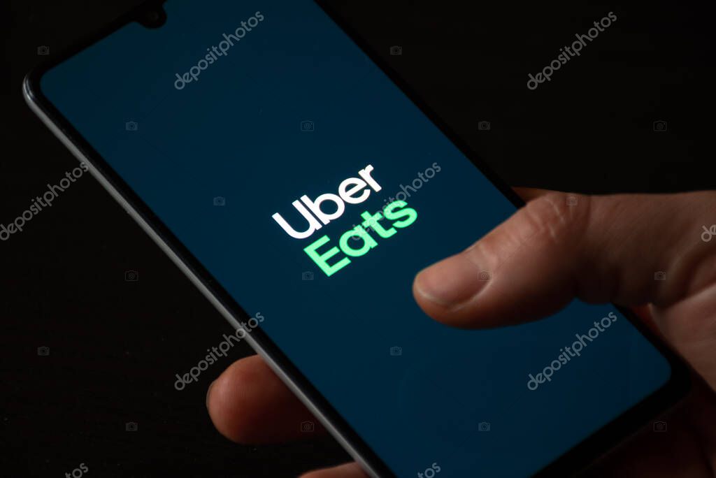Vilnius, Lithuania - November 18 2020: Uber Eats. Food order and delivery service. Takeaway food during Covid or Coronavirus pandemic, app on smartphone showing variety of food, pizza, pasta, sushi, fast food with hand