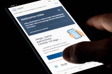 Vilnius, Litvanya - 25 Kasım 2020: Stop Covid, Korona Stop LT Litvanya, Litvanya yetkilisi COVID-19 veya Coronavirus takip uygulaması, izleme sistemi, parmak ile