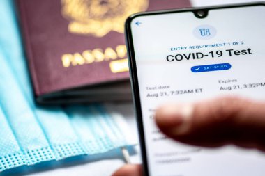 Roma, İtalya, - 17 Ocak 2021: Aşı pasaport uygulamasında pasaport veya vizeli ve yüz maskeli bir akıllı telefon, Covid-19 veya Coronavirus dokunulmazlık pasaportu sergilendi