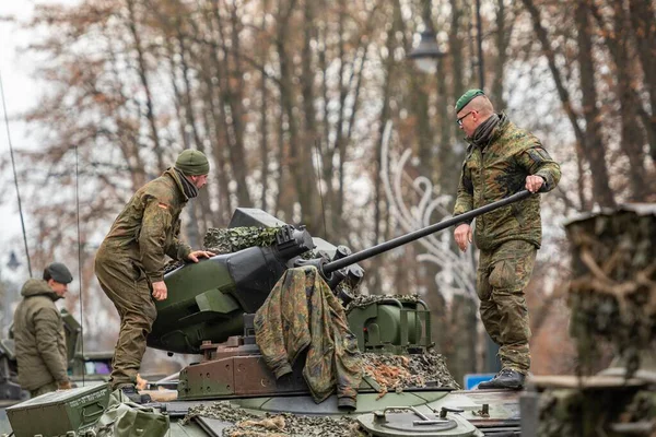 Vilnius, Litvanya - 22 Kasım 2025: Alman askerleri zırhlı bir Alman tankının taretinde yürüyen ve gökyüzünü gösteren bir otomatik top ile