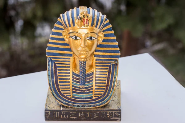 Ceramic souvenir representing the Mask of Tutankhamun a gold mask of the Egyptian pharaoh Tutankhamun. It was discovered by Howard Carter in 1925 in the Tomb of the Valley of the Kings, and is now housed in the Egyptian Museum in Cairo.