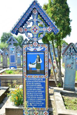 Spna Maramure 'deki Neşeli Mezarlığı' ndaki haç insanların ölüme güldüğü tek yer. Her haç neşeli renklerle boyanmıştır ve ölen kişinin yaşamından neşeli bir alıntı içerir.