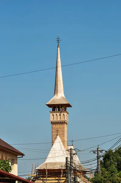 The Maramures wooden church belongs to the large family of Romanian wooden churches, with the multiple roof (in steps) narrow but high, with long towers at the western end of the church