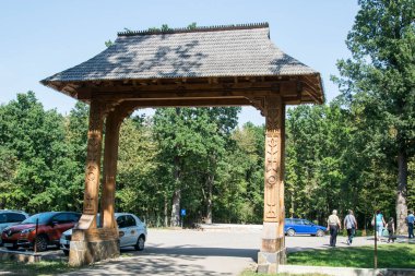 Maramures kapısı, meşe ağacından yapılmıştır, genellikle farklı geleneksel çiçek motiflerine sahip en az üç sütun ve kapının üst eşiği kiremitlerle kaplıdır.