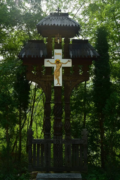 The cross at the side of the road is carved out of wood, with motifs in which the Orthodox cross and solar rosettes predominate, is located at forks and road intersections to ward off evil spirits