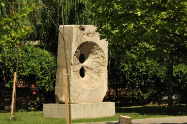 sculpture of a young woman with a large white sculpture