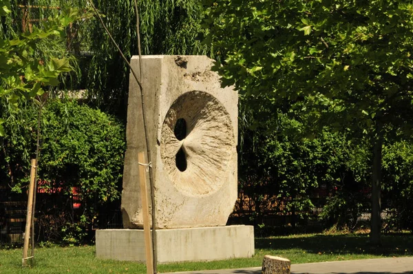 sculpture of a young woman with a large white sculpture