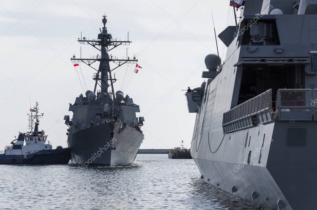 WARSHIPS - An Italian frigate and an American destroyer moored at a seaport wharf 