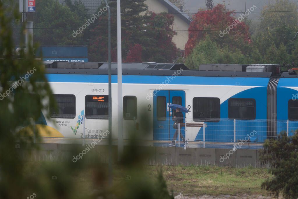 KOLOBRZEG, WEST POMERANIAN - POLAND - OCTOBER 12, 2025: Passenger train at the local railway station