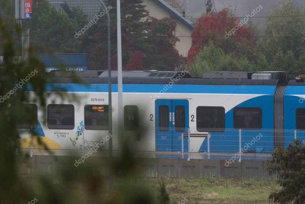 KOLOBRZEG, WEST POMERANIAN - POLAND - OCTOBER 12, 2025: Passenger train at the local railway station