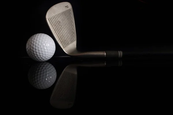 暗い背景にゴルフボールやゴルフクラブ — ストック写真
