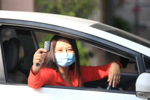 Молодая Женщина Медицинской Защитной Маской Лице Водит Машину Смотрит Камеру — стоковое фото