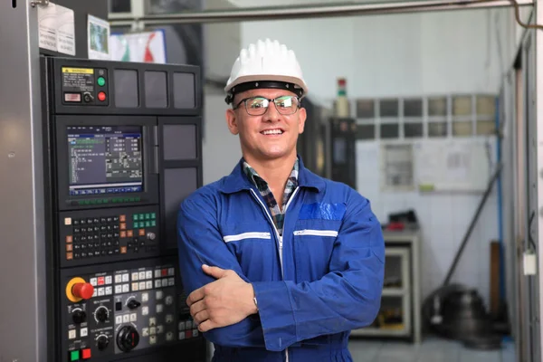 Male  Industrial Engineers in Hard Hats  with  machine. Assist production engineer in industry. He checking or push metalwork control in industrial In a plastic factory for car. Concept Successful Of Work.