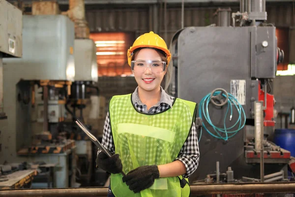 Female Industrial Engineers with  machine. Assist production engineer in industry. He checking or push metalwork control in industrial In a plastic factory for car. Concept Successful Of Work.