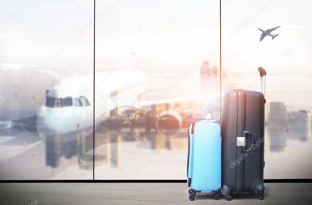 traveler suitcases in airport terminal waiting area,  interior with large windows, focus on suitcases ,summer vacation concept,Suitcases in airport departure lounge, airplane in background,
