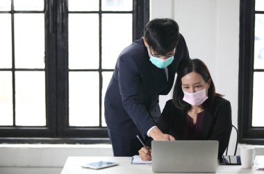 Maskeli insanlar ofiste çalışıyor Coronavirus ofis çalışanları Corona virüsü için maske takıyor. İş adamları sağlıklarını korumak ve korumak için maske takarlar. Bilgisayarla çalışan ofis. 