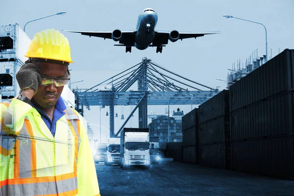 Close up of An African American handsome black engineer he is working in container box yard area,The world logistics  background or transportation Industry or shipping business, Container Cargo  shipment , truck delivery, airplane , import export Con