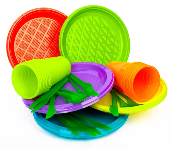Disposable bright plastic kitchenware stacked on white — Stock Photo, Image