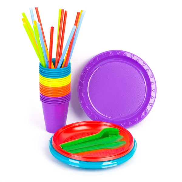 Disposable bright plastic kitchenware stacked on white Stock Photo by