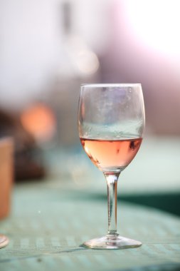 Glass of rosé on a table, with a soft afternoon light.