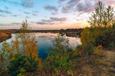 Günbatımında göllü ve bulutlu sonbahar manzarası. Leningrad bölgesi.