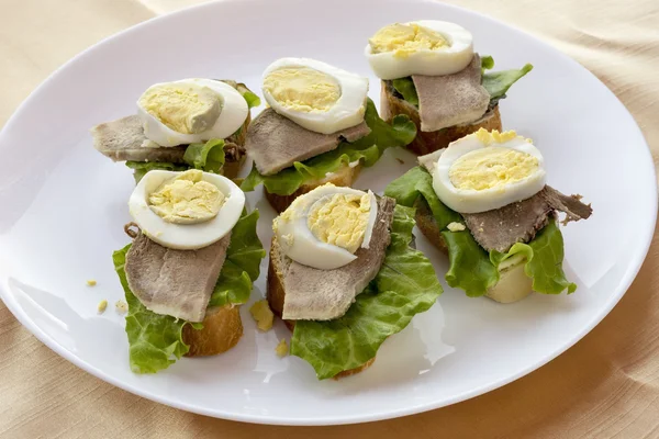 Sandwiches with boiled egg and tongue. — Stock Photo, Image