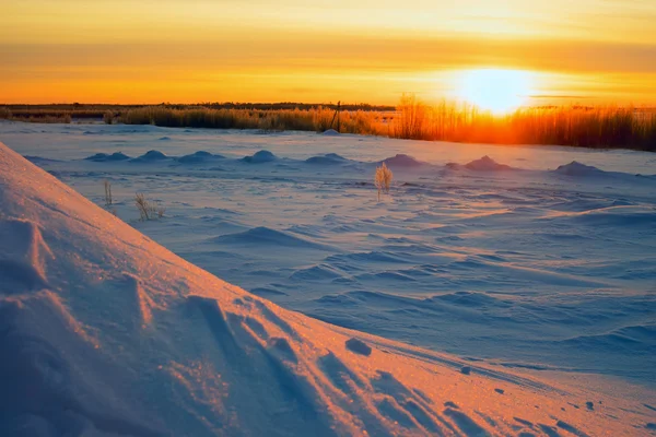 Stralende zon bij zonsondergang in de winter met grote sneeuw driften. — Stockfoto