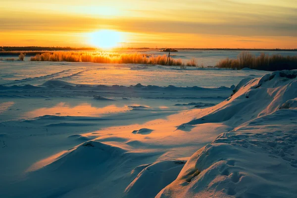 Felle zon zonsondergang in de winter met grote sneeuw driften. — Stockfoto