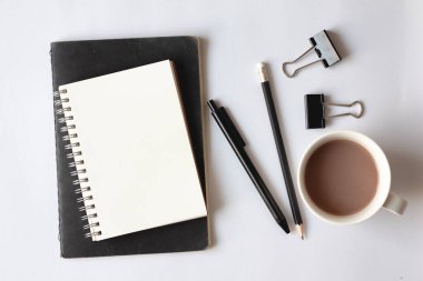 Beyaz arka planda defter ve kahve.