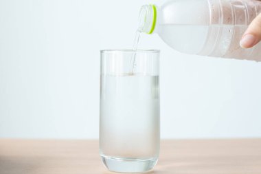 Kadın masadaki bardağa su döktü.