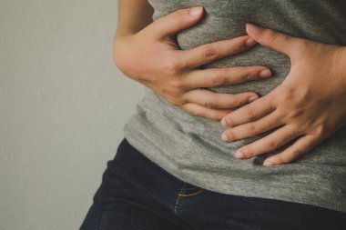Young woman suffering from abdominal pain.Chronic gastritis or abdomen bloating and healthcare concept.