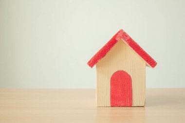 Wood house on blue background,new home in a housing development or community,minimal.