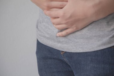 Young woman suffering from abdominal pain.Chronic gastritis or abdomen bloating and healthcare concept.