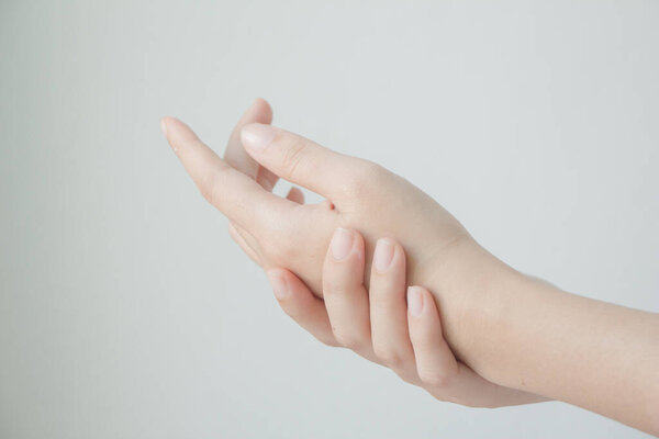 Woman hands applying hand cream.